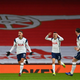Erik Lamela (L) celebrates scoring the opening goal during the English Premier League football match between Arsenal and Tottenham Hotspur at the Emirates Stadium in London